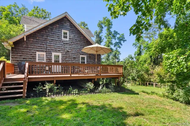 a view of a house with a yard and deck