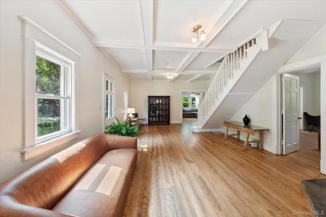 a view of entryway and hall with wooden floor