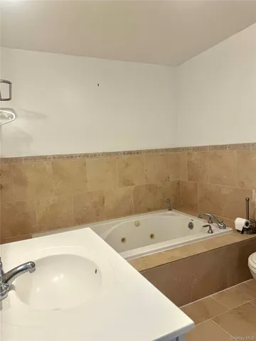 a bathroom with a bathtub and shower