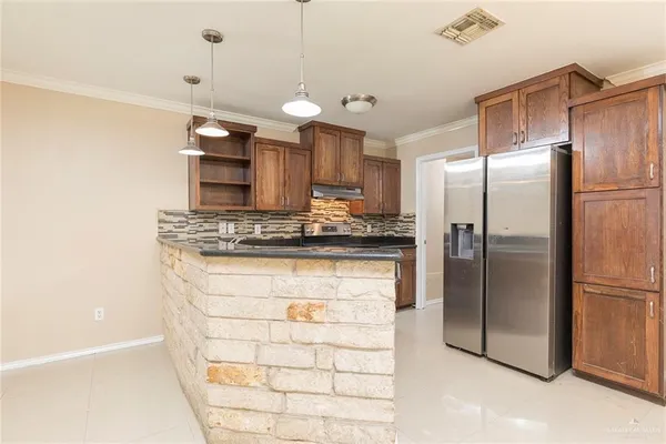 a kitchen with stainless steel appliances granite countertop a refrigerator and a sink