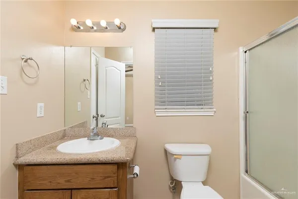 a bathroom with a sink a toilet and mirror