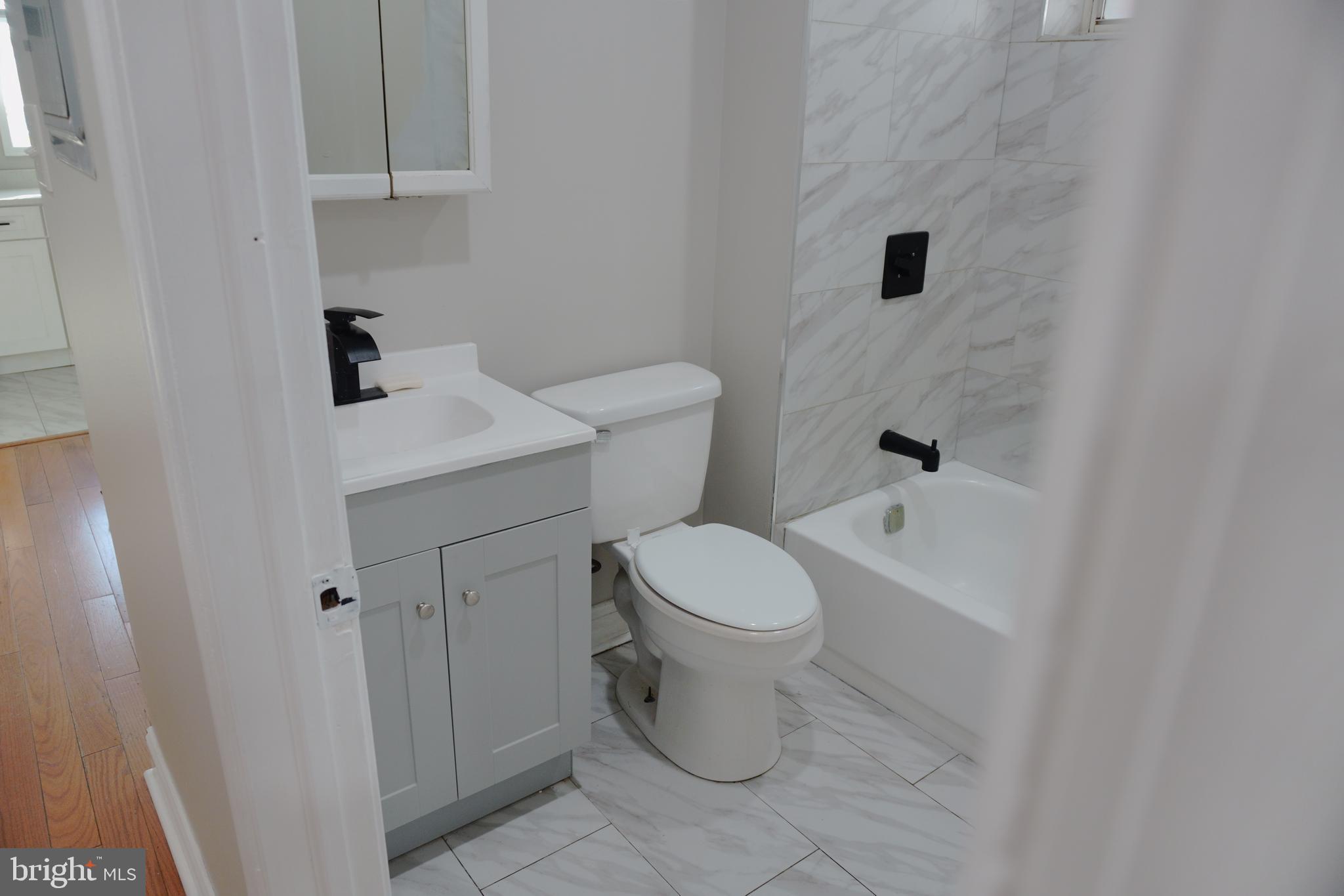 5538 Master Street Philadelphia, PA 19131 - Photo 11 of 30 a white toilet sitting next to a bathroom sink