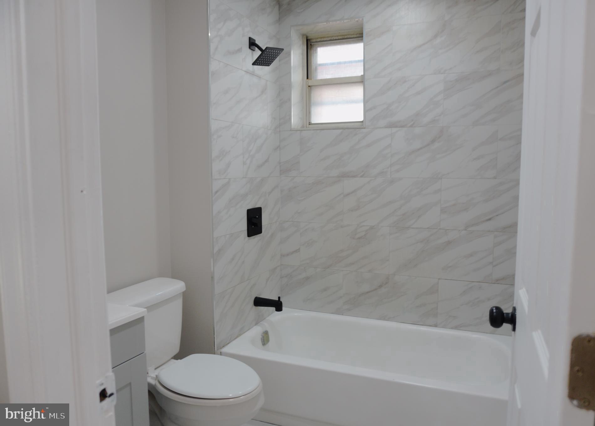 5538 Master Street Philadelphia, PA 19131 - Photo 12 of 30 a bathroom with a toilet and a bathtub