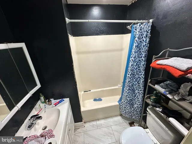 a bathroom with a toilet and a shower curtain