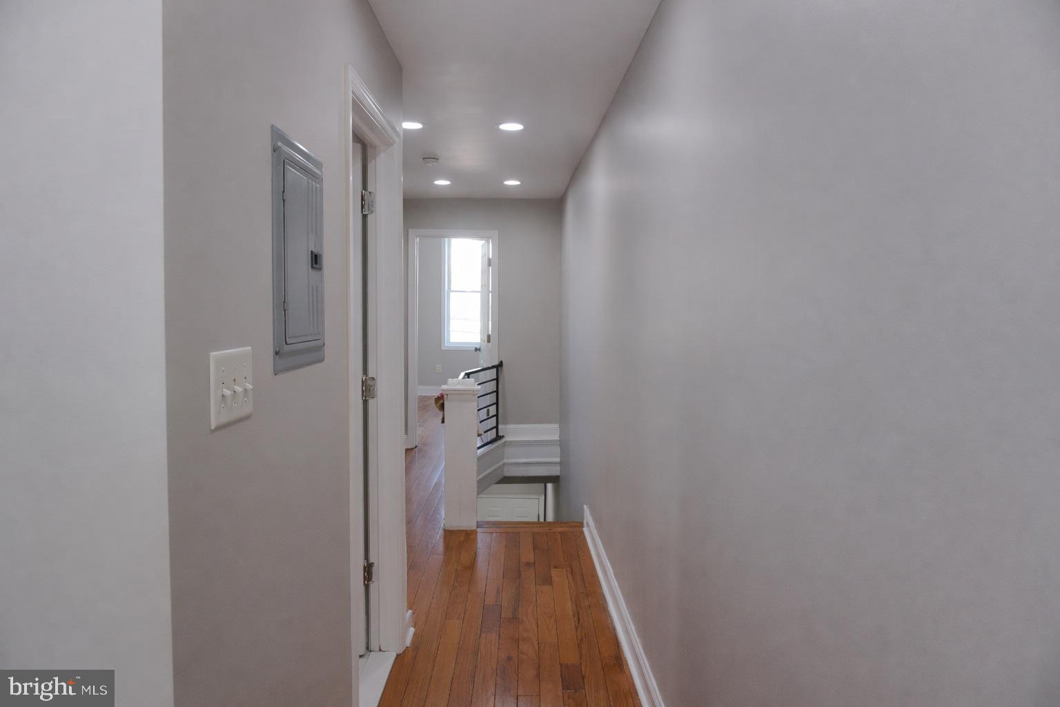 5538 Master Street Philadelphia, PA 19131 - Photo 9 of 30 a view of a hallway with wooden floor and a bathroom