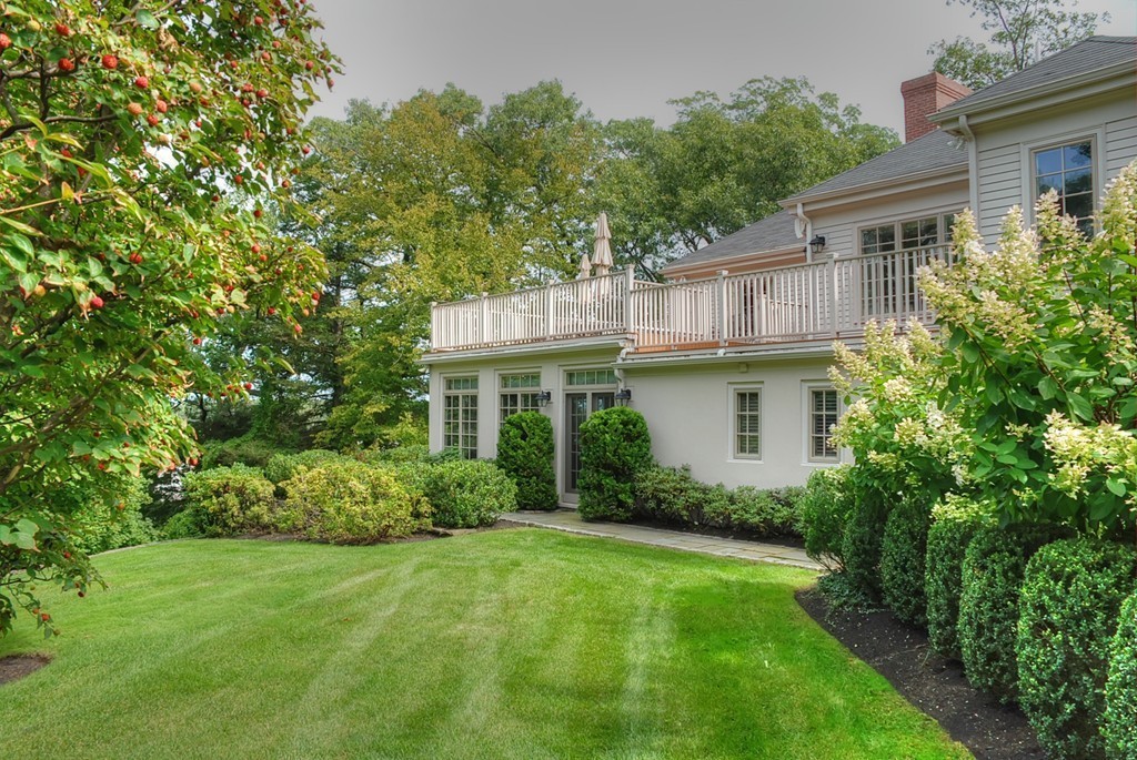 46 Chestnut Hill Road Newton, MA 02467 - Photo 2 of 5 a front view of a house with a garden