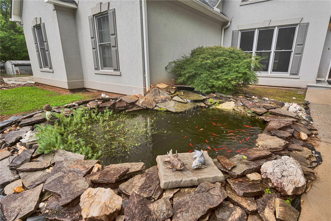 1016 Campbell Road Belton, SC 29627 - Photo 48 of 50 A tranquil pond with a stone waterfall feature adds a serene touch to the home's exterior.