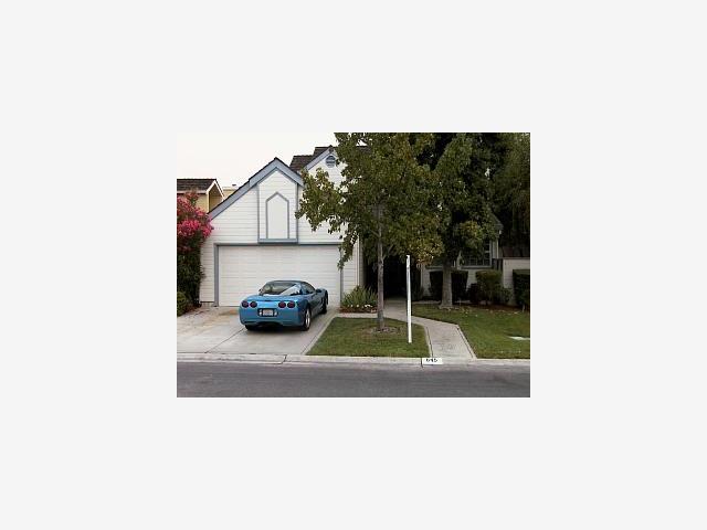 a picture of a bench in front of a house