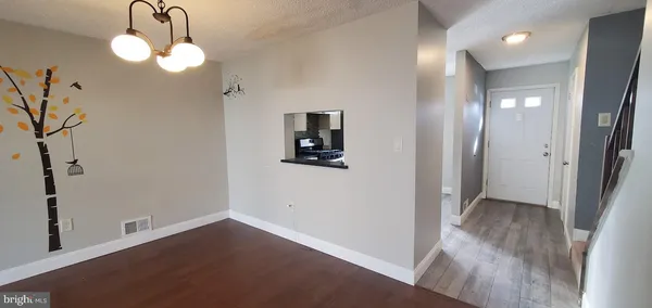 wooden floor in an empty room with a mirror