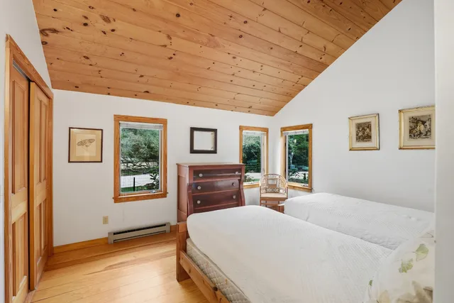 a bathroom with a granite countertop sink a mirror and a shower