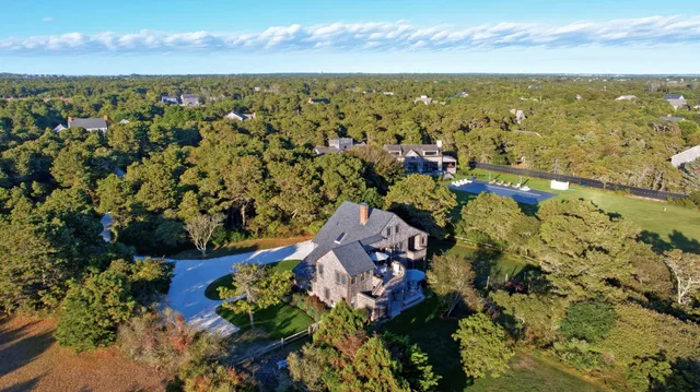 an aerial view of a house with a yard and lake view