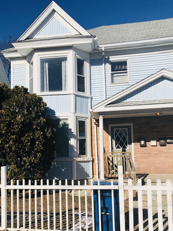 a front view of a house with a fence