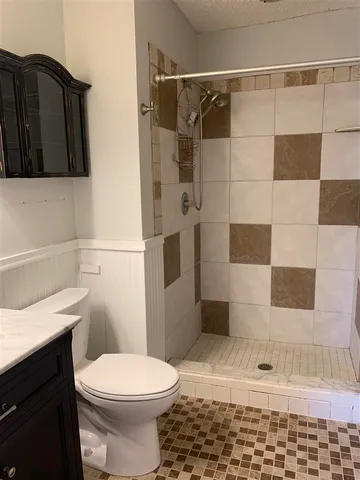 a bathroom with a toilet and a shower
