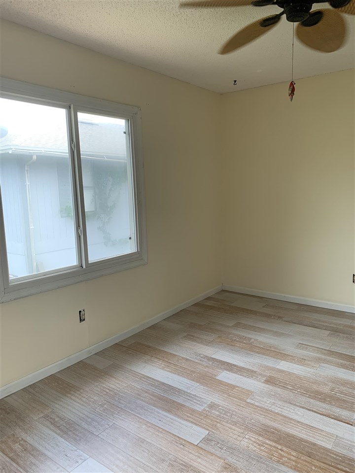 6484 Brevard Street St. Augustine, FL 32080 - Photo 16 of 20 a view of an empty room with wooden floor and a window