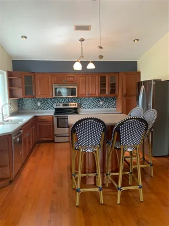 a view of a kitchen with dining area and wooden floor