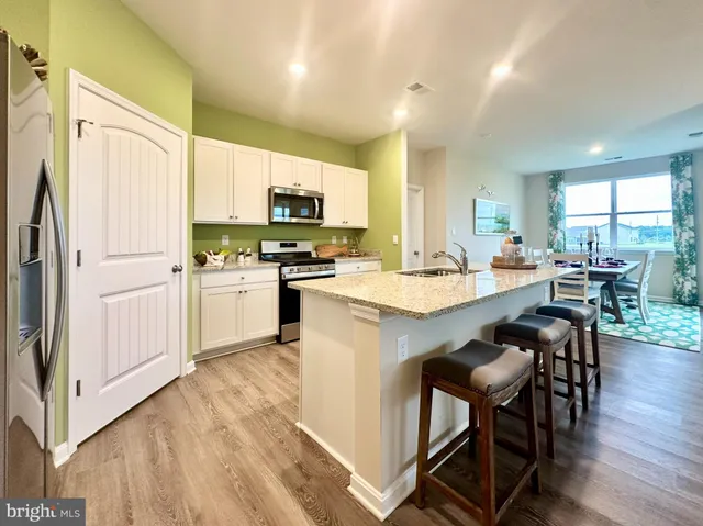 a kitchen with a sink a microwave and refrigerator