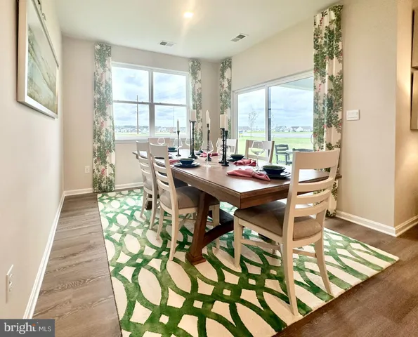 a room with lots of table chairs and windows