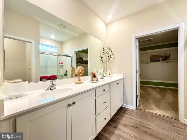 a bathroom with a double vanity sink mirror and double