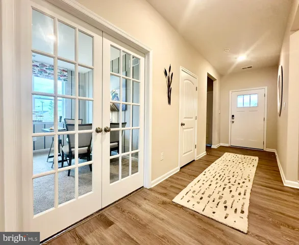 a view of wooden floor in a room with a window