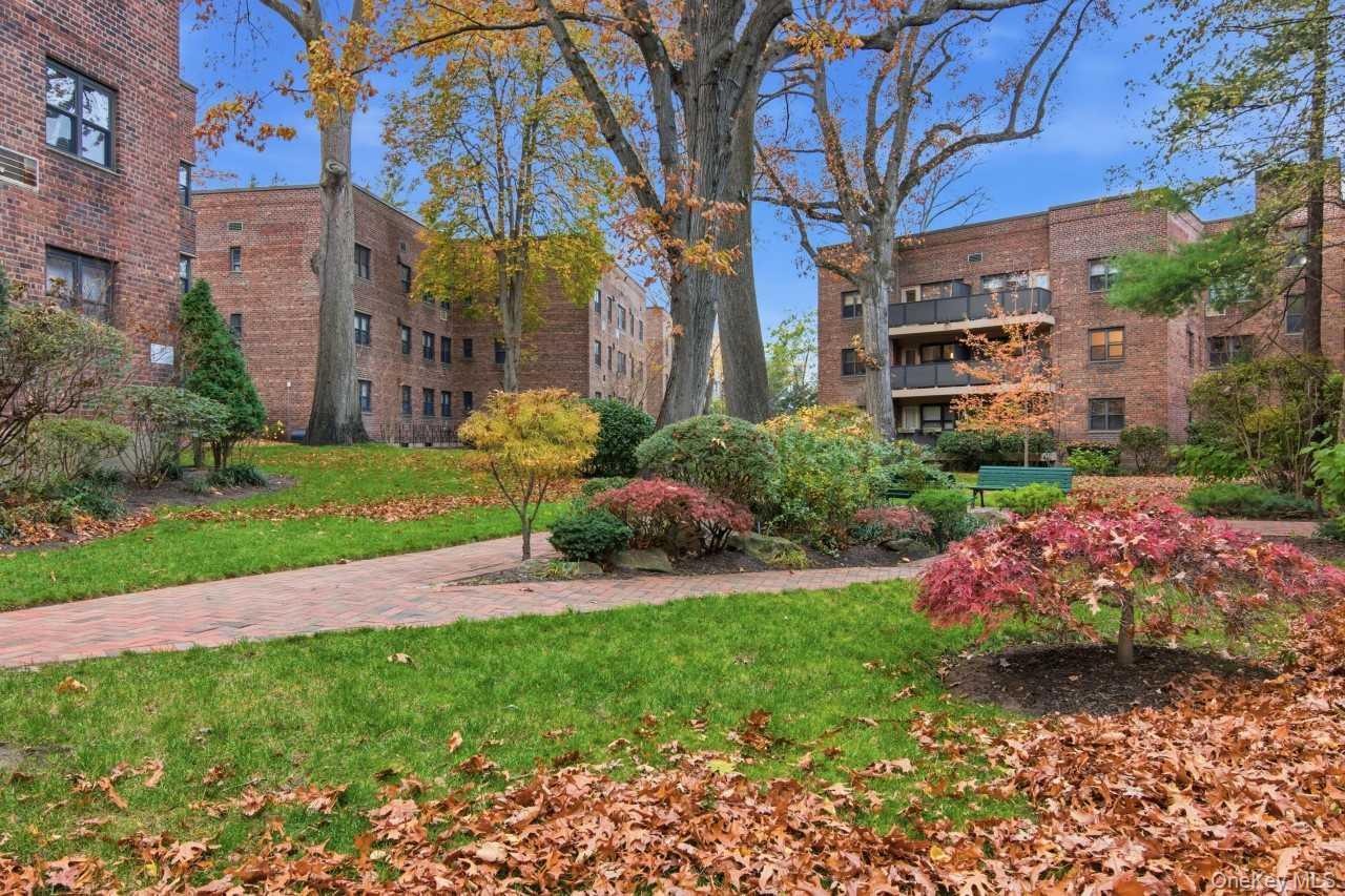 52 Brompton Road, Unit 52 Great Neck, NY 11021 - Photo 16 of 17 a view of a street with a building in the background
