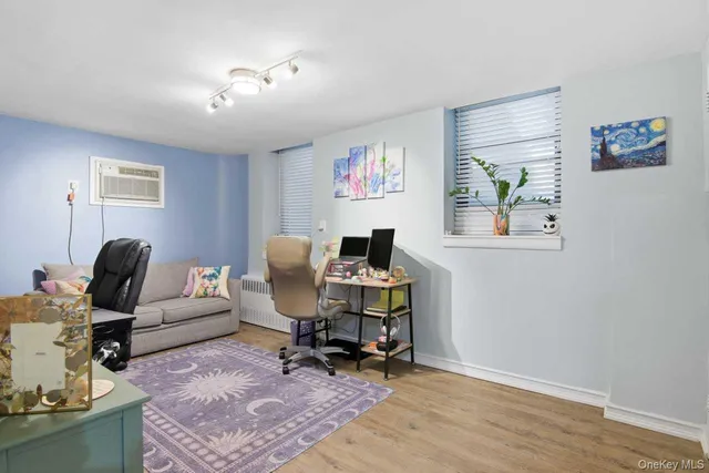 a work room with furniture and wooden floor