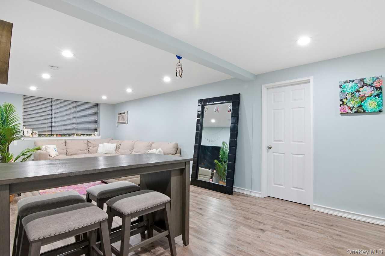 52 Brompton Road, Unit 52 Great Neck, NY 11021 - Photo 6 of 17 a kitchen with a table and chairs in it