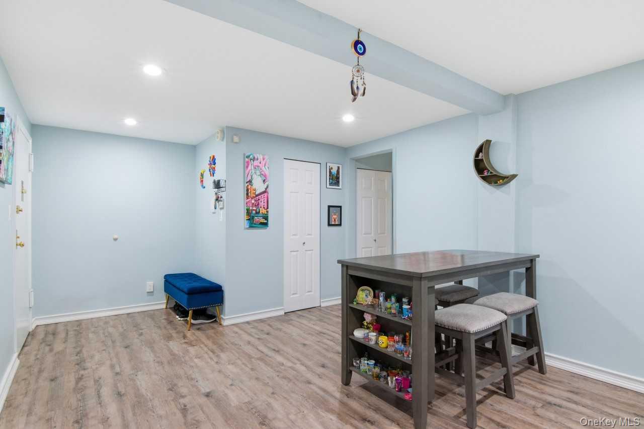 52 Brompton Road, Unit 52 Great Neck, NY 11021 - Photo 7 of 17 a view of a room with furniture and wooden floor