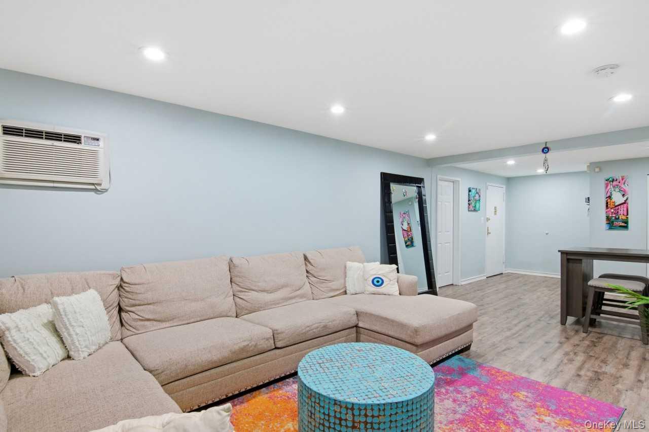 52 Brompton Road, Unit 52 Great Neck, NY 11021 - Photo 9 of 17 a living room with furniture