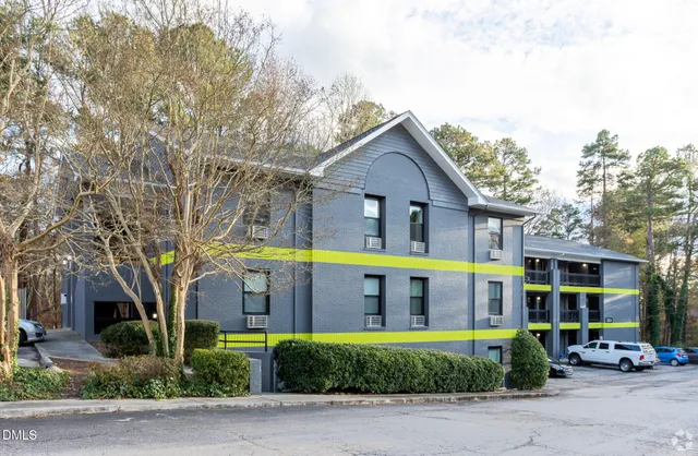 a front view of building with cars parked