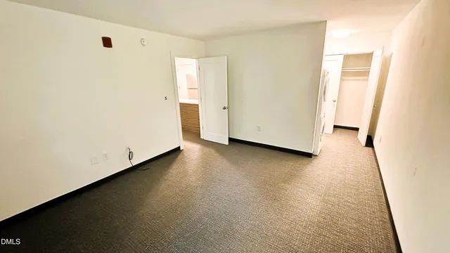a view of a room with wooden floor and a window