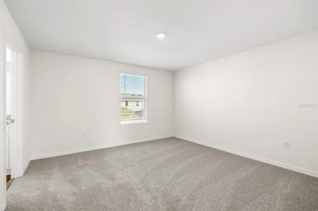 a bedroom with a bed and a potted plant