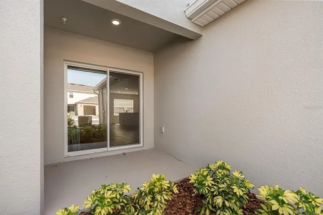 a large kitchen with cabinets wooden floor and a window