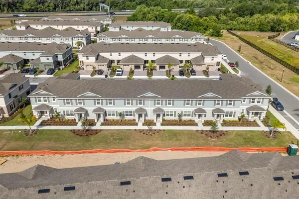 an aerial view of a house with outdoor space