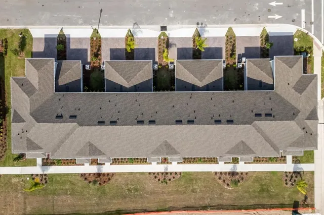 an aerial view of a residential houses with outdoor space