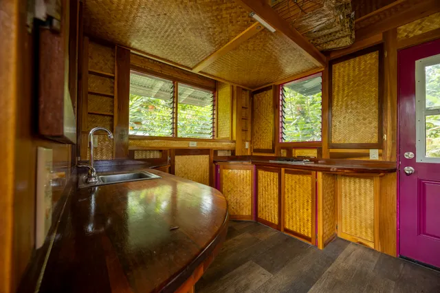 a view of a backyard with brick wall and potted plants