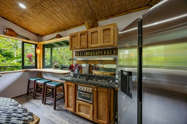 a open kitchen with stainless steel appliances granite countertop a stove and a refrigerator