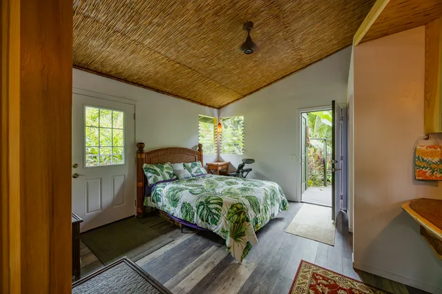 a bedroom with 2 bed and a window
