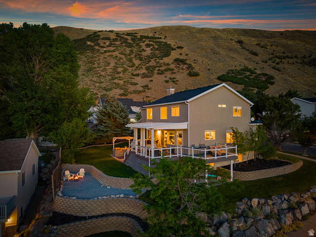 14883 Tooele Lane Draper, UT 84020 - Photo 43 of 49 Two-story residence featuring a large elevated deck with white railings, offering extensive outdoor living space