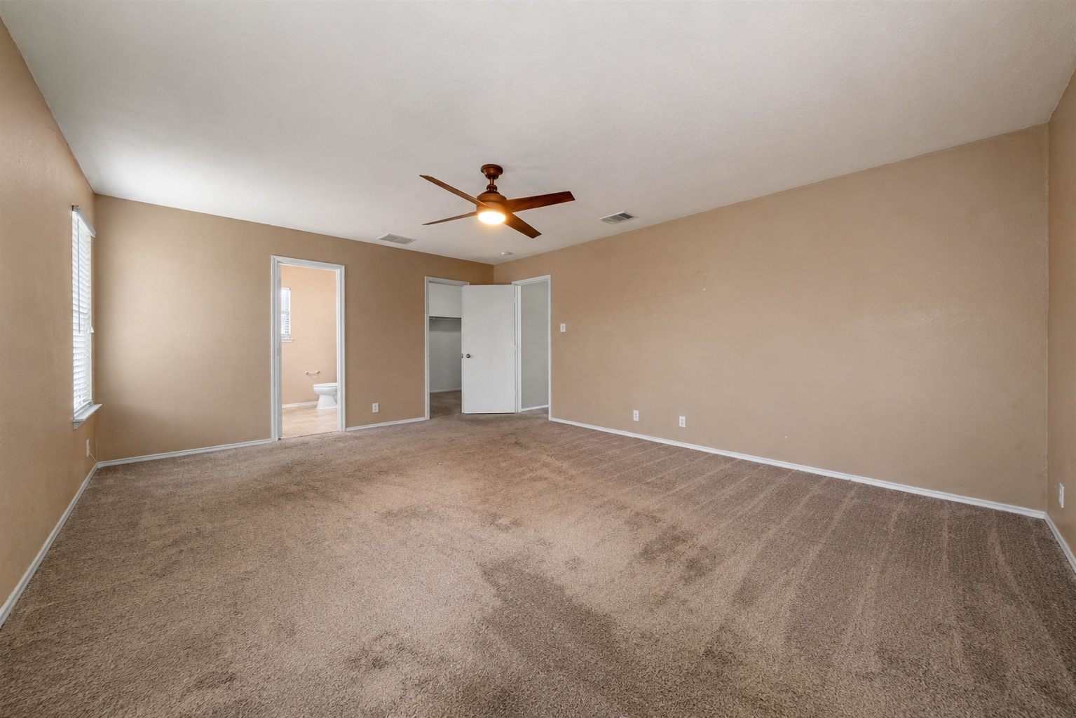 122 Rummel Drive Kyle, TX 78640 - Photo 10 of 18 A spacious primary bedroom with a large closet and an en suite bathroom.