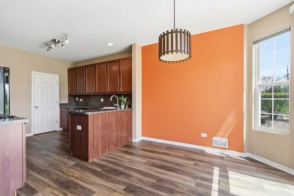 a kitchen with kitchen island granite countertop wooden cabinets and a stove