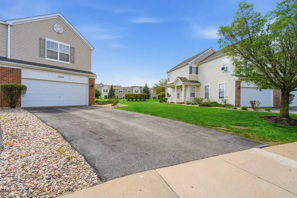 a front view of a house with a yard and garage