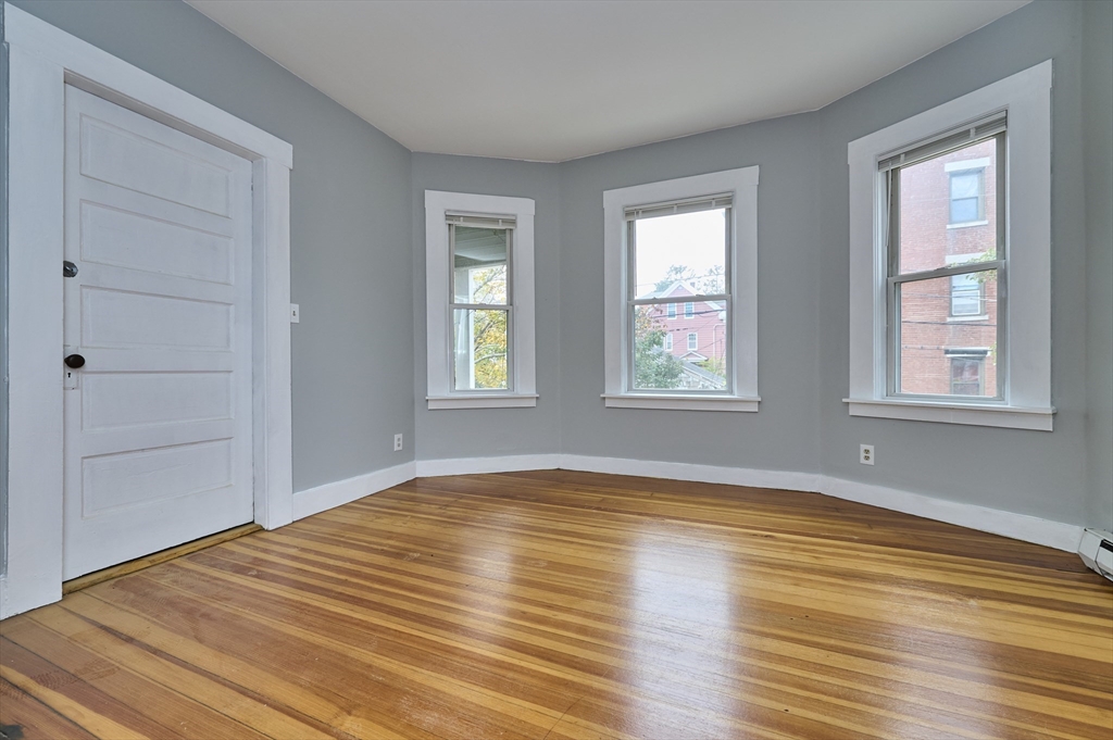 41 Salem Street, Unit 2L Salem, MA 01970 - Photo 5 of 18 a view of empty room with wooden floor and fan