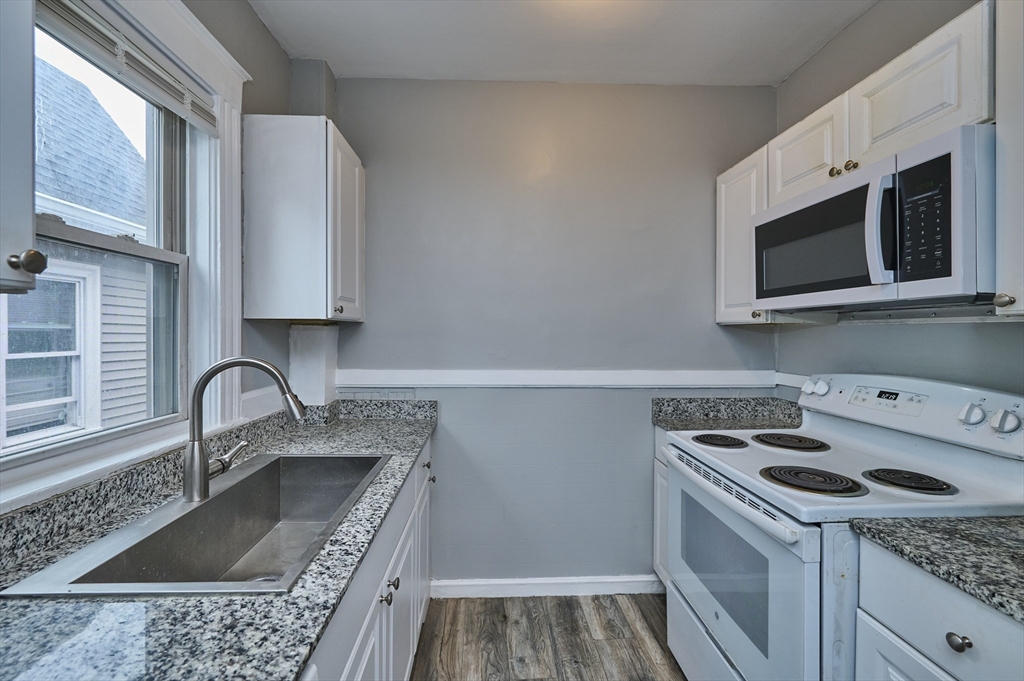 41 Salem Street, Unit 2L Salem, MA 01970 - Photo 7 of 18 a kitchen with a sink stove and microwave