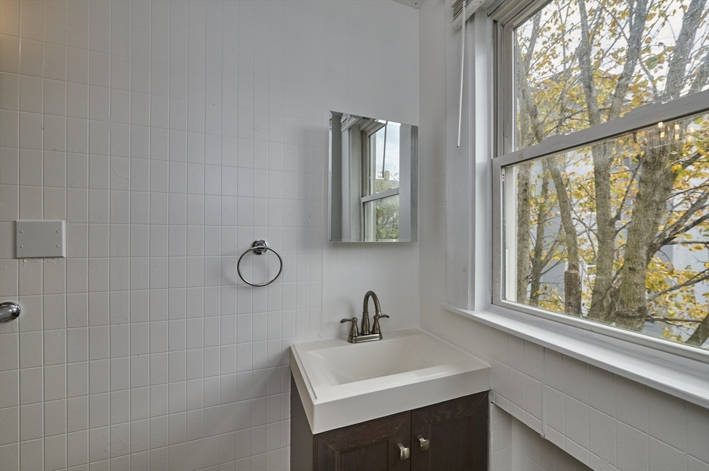 41 Salem Street, Unit 2L Salem, MA 01970 - Photo 10 of 18 a bathroom with a sink mirror and a window