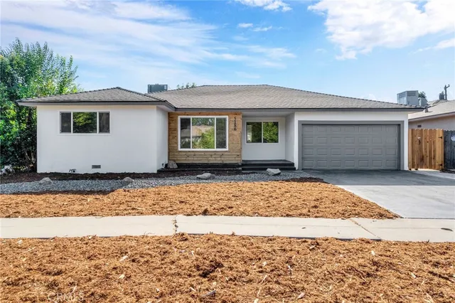 a view of front door and a yard