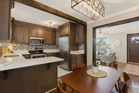 a kitchen with a dining table and chairs