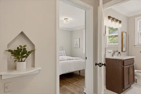 a view of hallway with sink and wooden floor