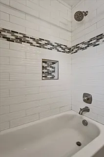 a bathroom with a tub and a shower