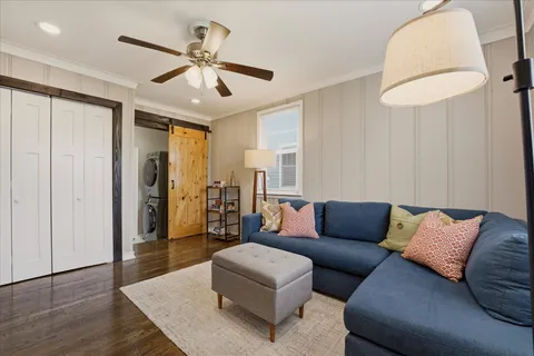 a living room with furniture and a chandelier