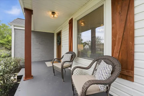 a view of two chairs in the balcony